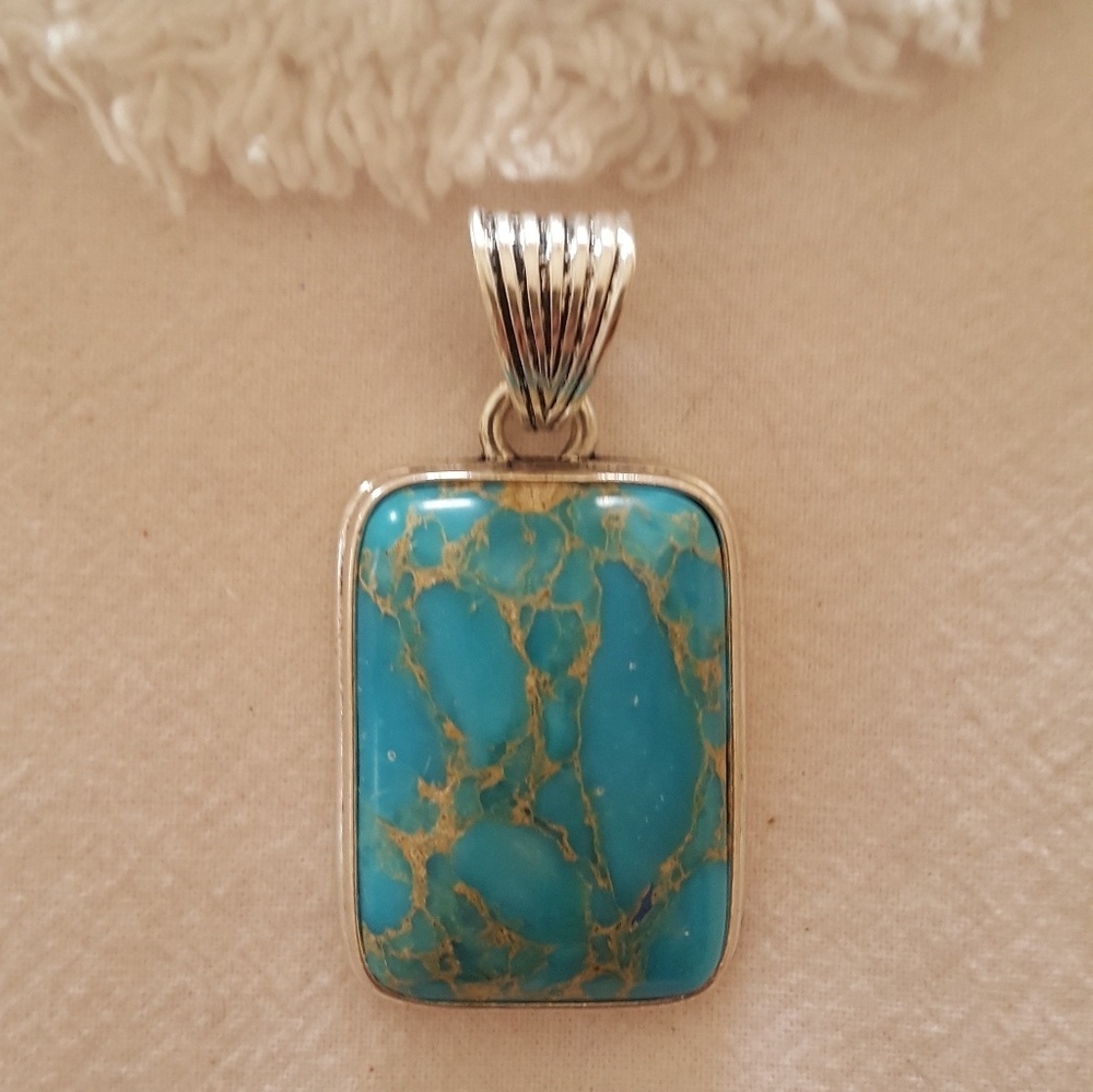Tourqous pendant with silver slide.